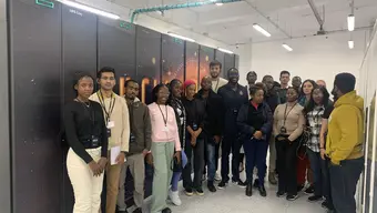 UNESCO Fellows at Academic Computer Center Cyfronet AGH during a guided visit, viewing presentations on supercomputing infrastructure and learning about high-performance systems used for advanced scientific and industrial research.